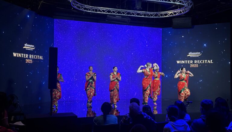 This image captures a vibrant performance at the Shawnee Performing Arts Winter Recital 2025, featuring five dancers in…