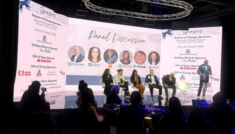 # Panel Discussion at Charity Event This image captures a "Panel Discussion" at what appears to be a formal charitable gala…