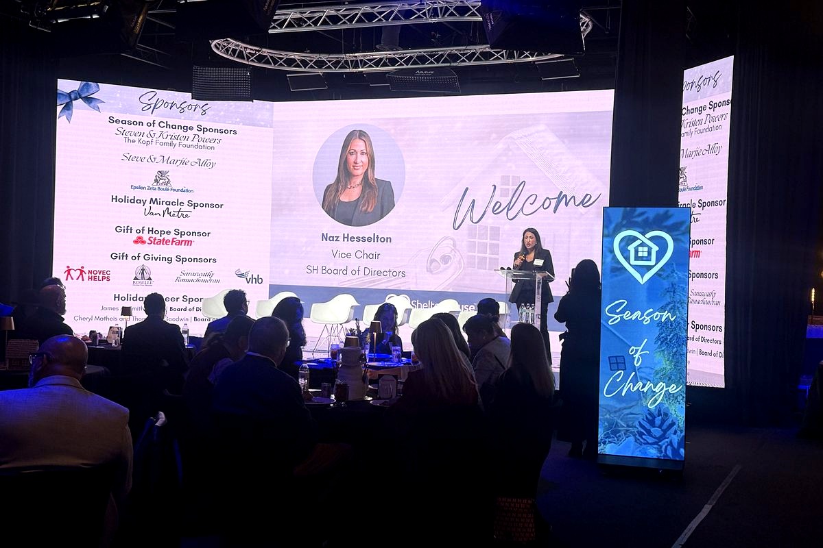 This image captures a professional gala or charity event where Naz Hesselton, Vice Chair of the SH Board of Directors, is…