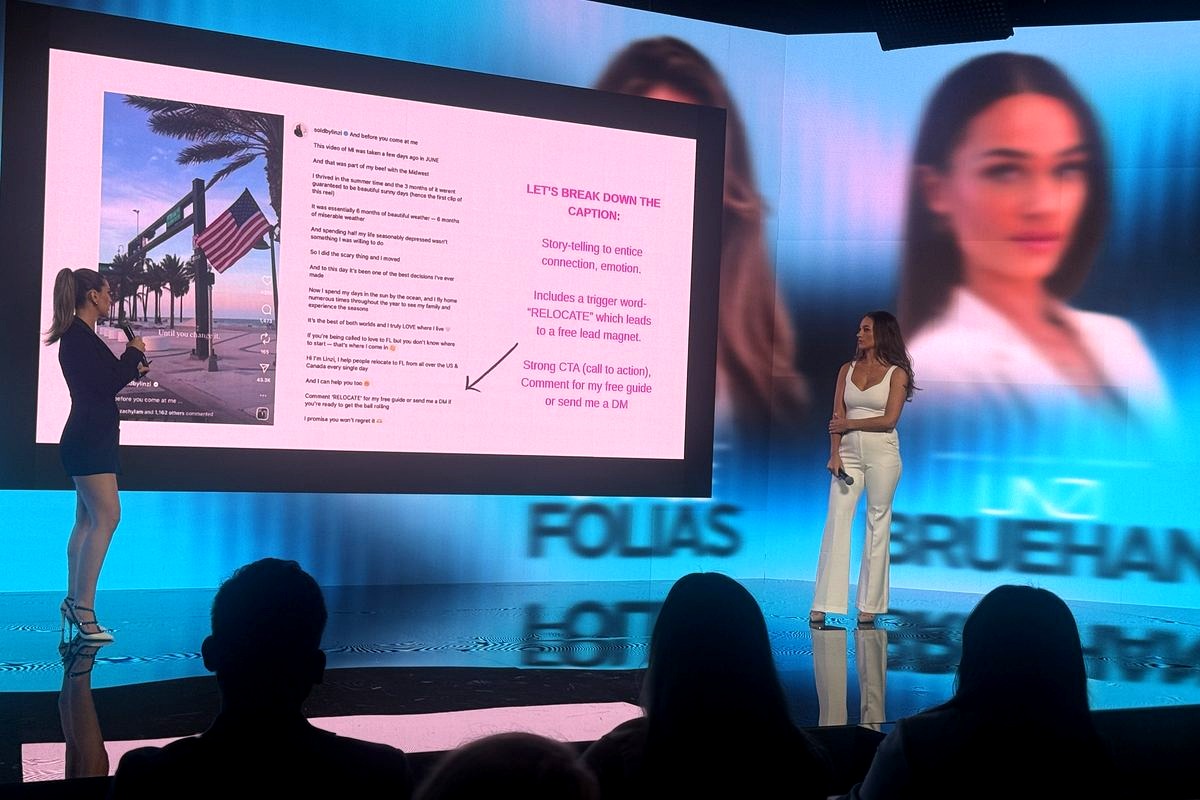 # Image Description
This image shows a digital marketing presentation or conference talk where a speaker in a white outfit…