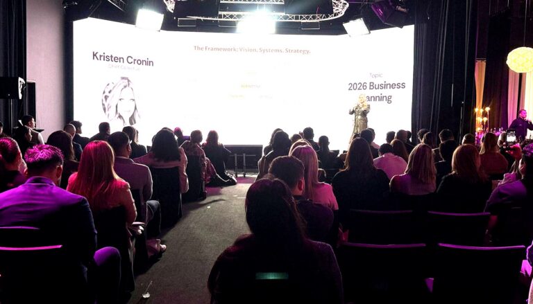 This image captures a professional conference or business seminar where Kristen Cronin, Chief Collective, presents on "2026…