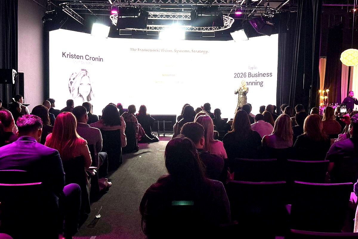 This image captures a professional conference or business seminar where Kristen Cronin, Chief Collective, presents on 