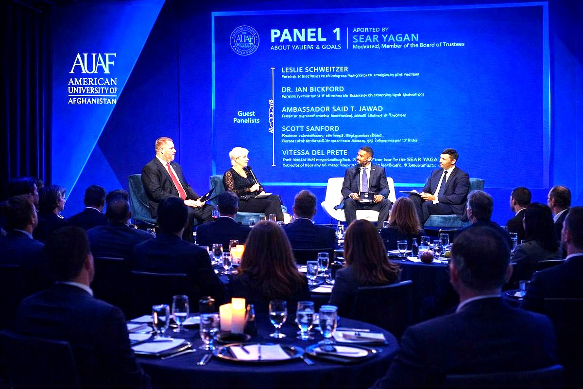 a professional panel discussion at the American University of Afghanistan (AUAF) event, with four guest panelists seated on…