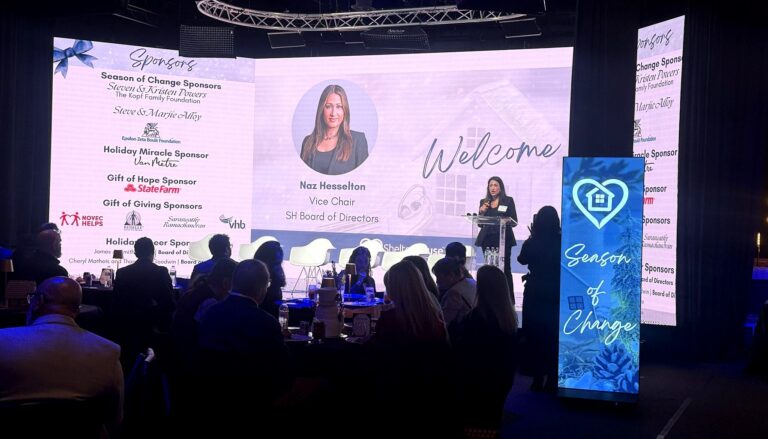 This image captures a professional gala or charity event where Naz Hesselton, Vice Chair of the SH Board of Directors, is…